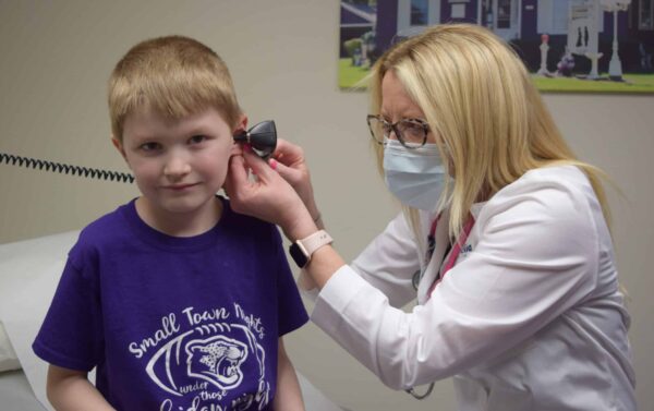 Carolyn Drevlow in Truman Provider conducting a child wellness exam.
