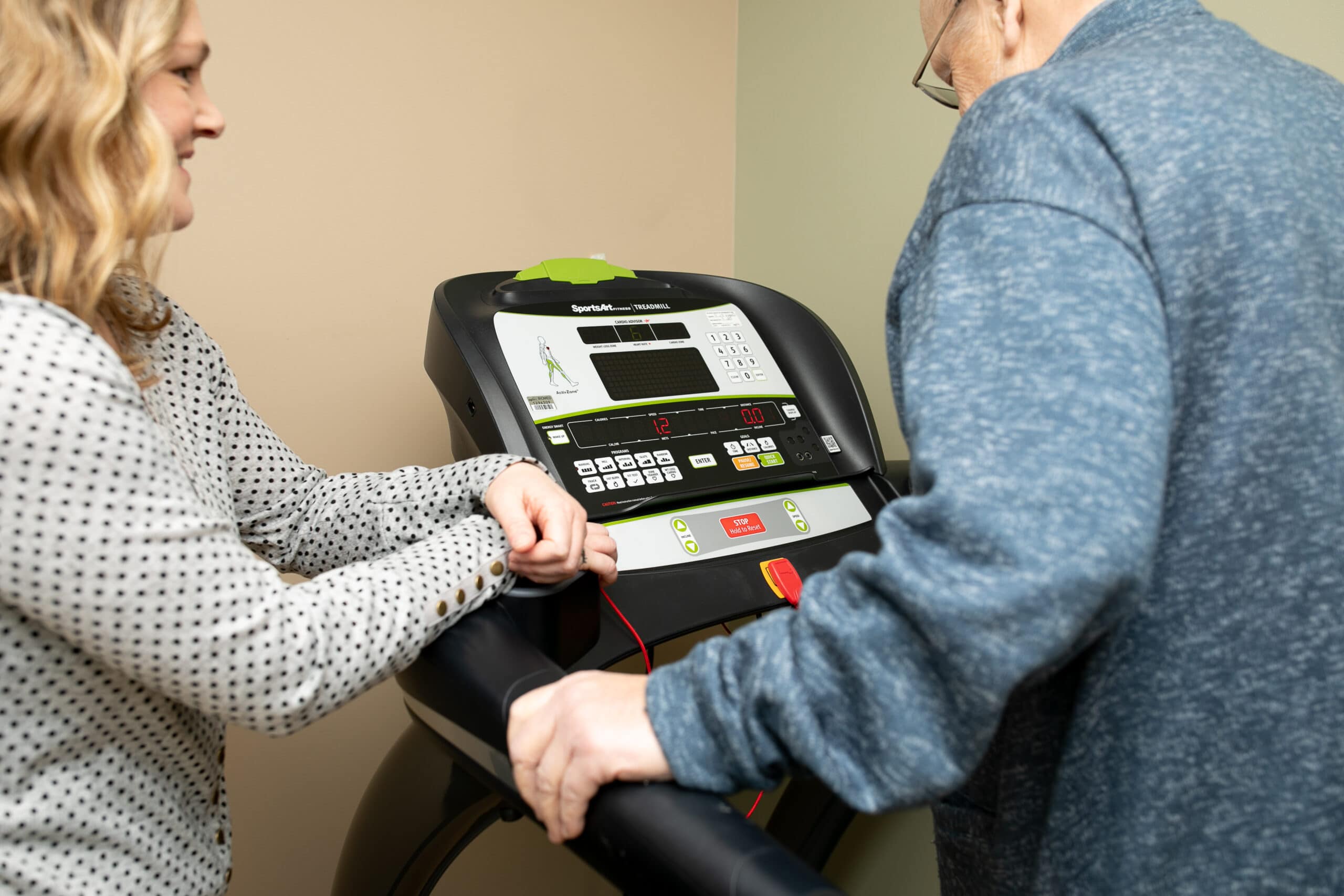 provider talking with patient on a treadmill