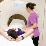 Caregiver providing a CT to a patient