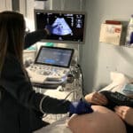 Caregiver providing an ultrasound to a patient